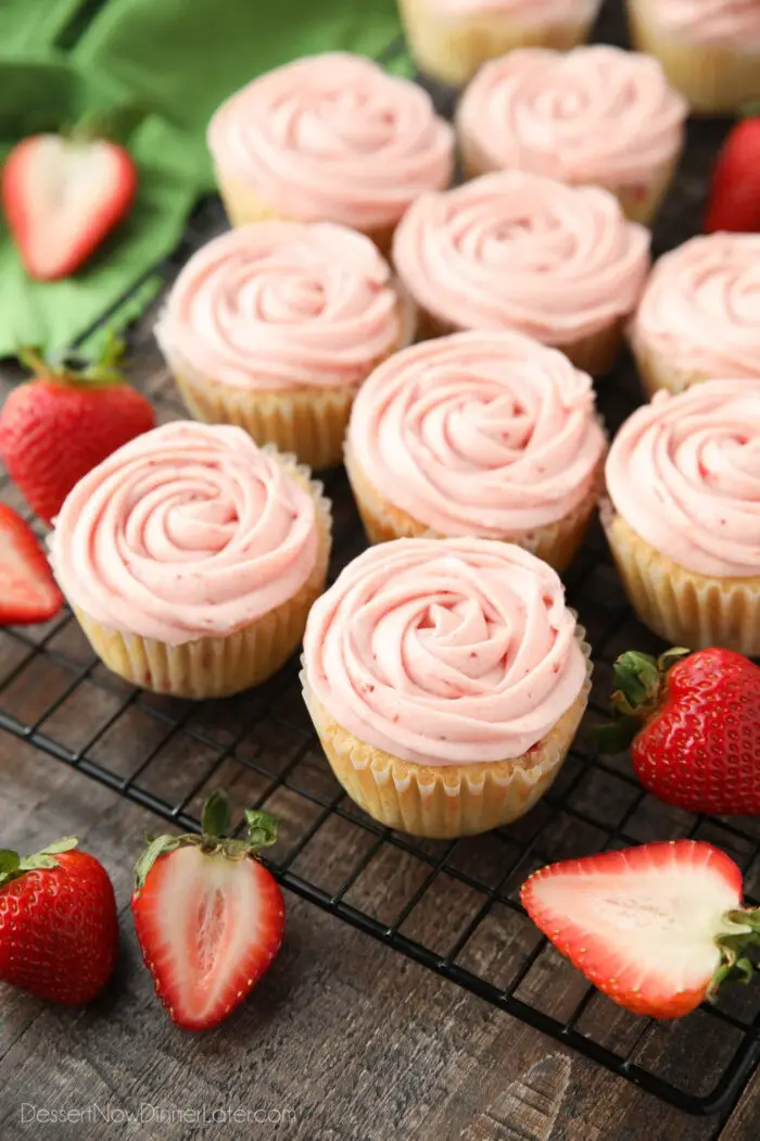 Fresh strawberry cupcakes with strawberry buttercream rosettes piped on top.