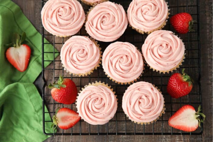 Rosettes piped onto fresh strawberry cupcakes.