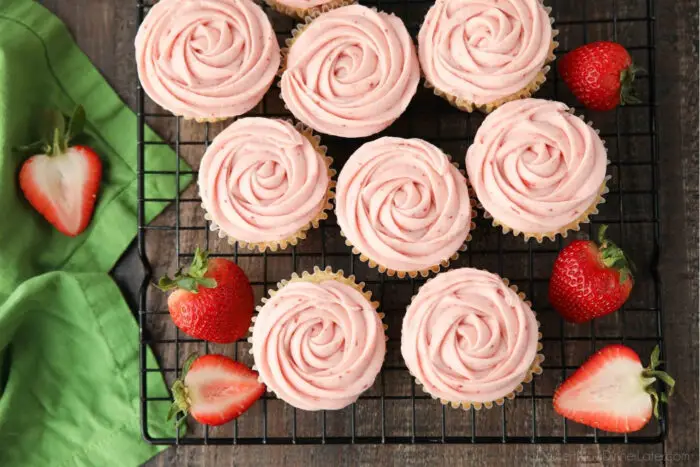 Rosettes piped onto fresh strawberry cupcakes.