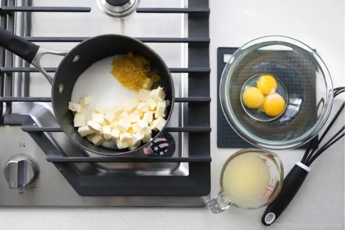 How to make lemon curd. Five ingredients: granulated sugar, lemon zest, lemon juice, butter, and egg yolks.