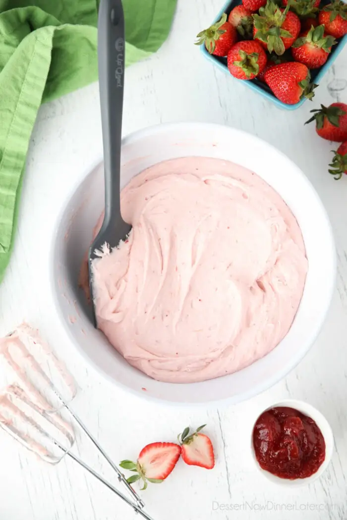 Strawberry buttercream frosting made with jam in a bowl.
