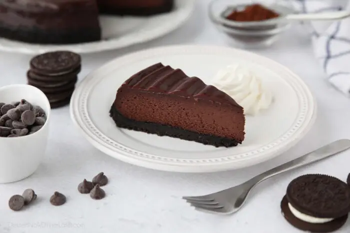 Triple Chocolate Cheesecake with an Oreo crust, cocoa powder cheesecake filling, and swirled chocolate ganache on top.