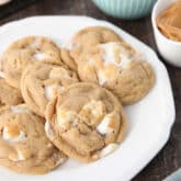 Fluffernutter cookies on a plate with bowls of mini marshmallows and peanut butter in the background.