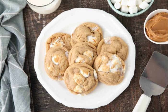 Fluffernutter cookies on a plate with a glass of milk next to it.