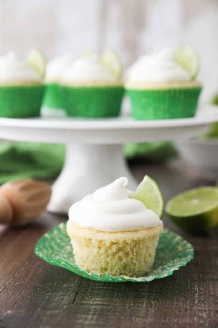 Key lime cupcake on wrapper that has been peeled down on the sides.