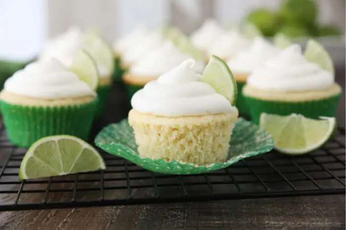 Key lime cupcake on wrapper that has been peeled down on the sides.