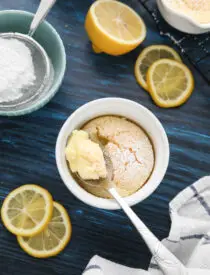 Spoonful of lemon pudding cake in ramekin.