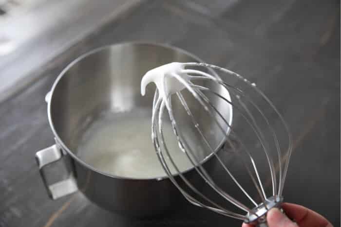 Whisk demonstrating egg whites with soft peaks.