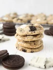 Four cookies and cream cookies stacked on top of each other.