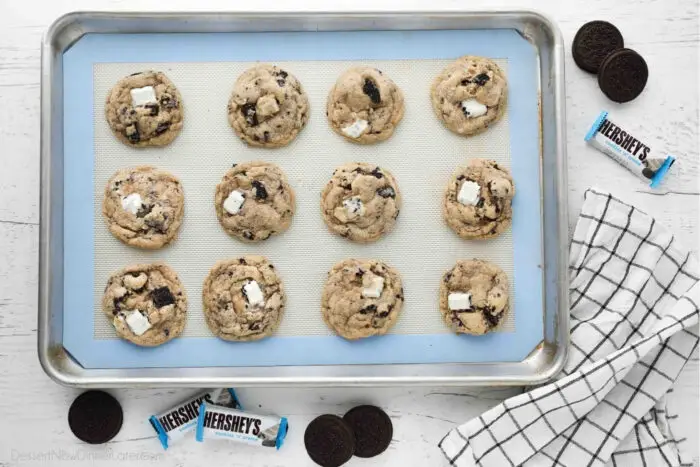 Cookie tray with baked cookies and cream cookies. Oreos and Hershey's Cookies 'n' Creme candy bars on the side.