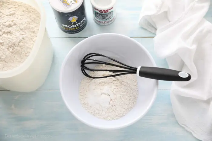 Dry ingredients in a bowl with a whisk.