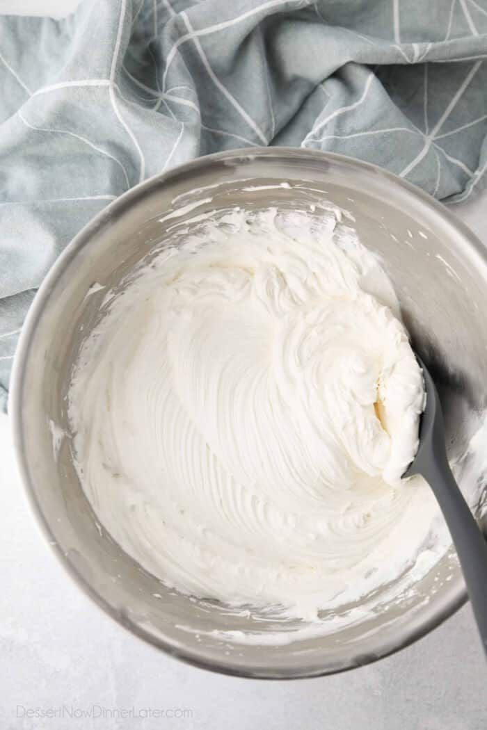 Bowl with ripples of cream cheese whipped cream frosting.
