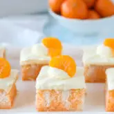 Close up of a slice of orange poke cake.