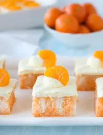 Close up of a slice of orange poke cake.