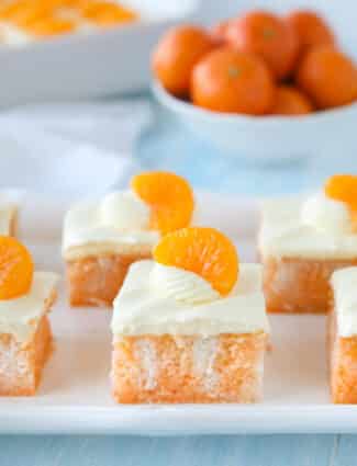 Close up of a slice of orange poke cake.