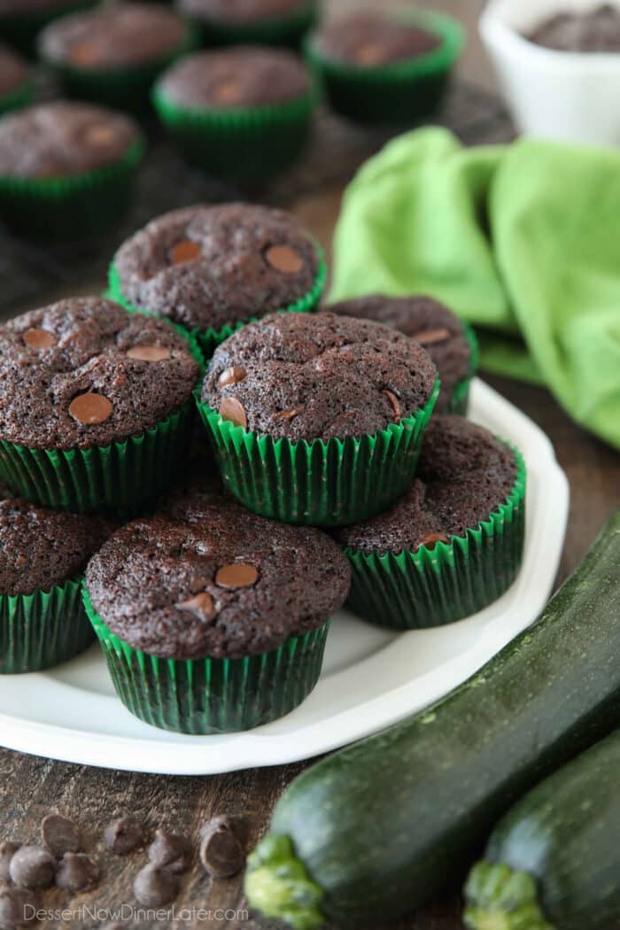 Plate full of chocolate zucchini muffins with chocolate chips.