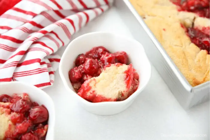 Close up of cherry cobbler in a small bowl.