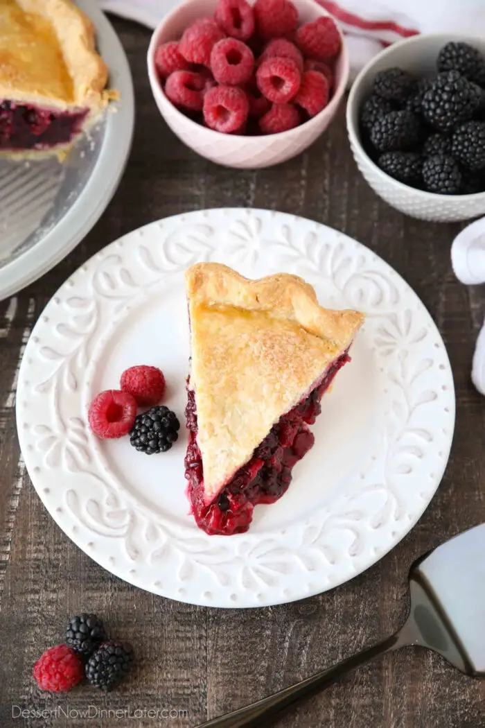 Top view of a slice of mixed berry pie in homemade crust.