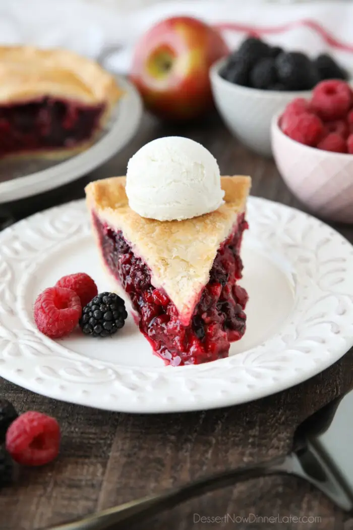 Slice of Razzleberry Pie with a scoop of vanilla ice cream on top.