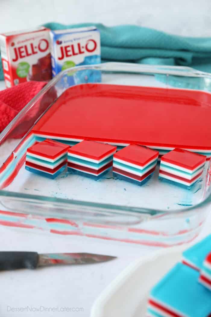 Red, white and blue layered jello cubes in dish.