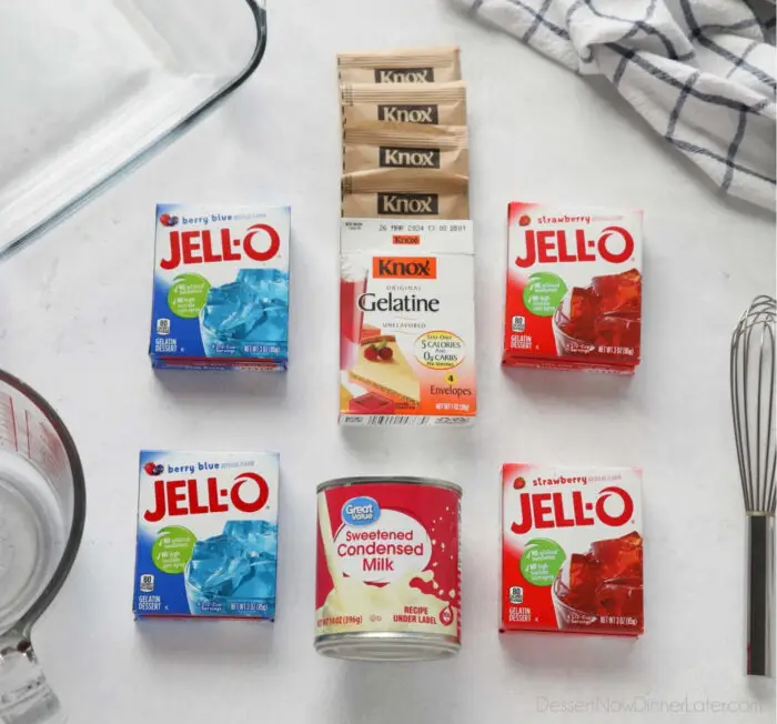 Ingredients for red white and blue jello. 2 small boxes of Berry Blue Jello, two small boxes Strawberry Jello, 4 packets Knox Gelatine, 1 can Sweetened Condensed Milk, and boiling water.