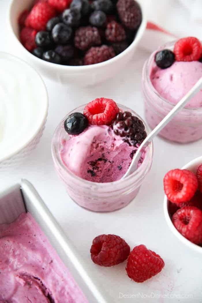 Close up of a small jar of berry frozen yogurt after some has been eaten.