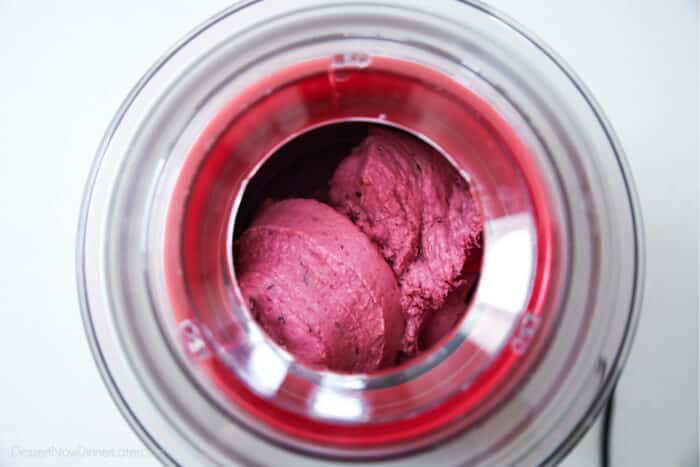 Berry frozen yogurt churning in ice cream maker.