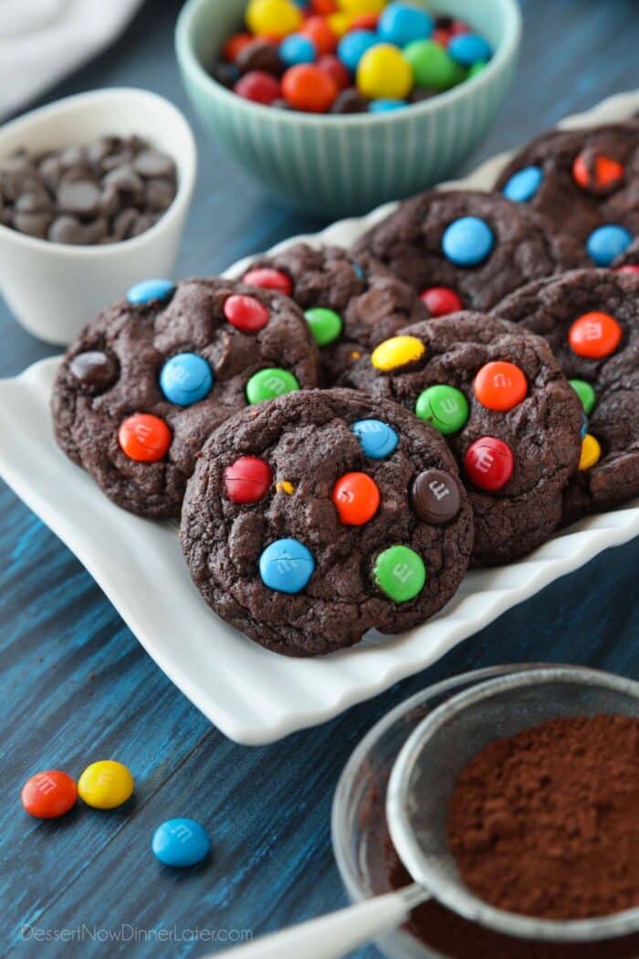 Chocolate cookies on a plate made with cocoa powder, chocolate chips and M&M's.