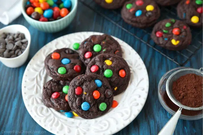 Plate full of chocolate M&M cookies with extra M&M's.