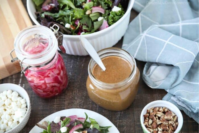 Our favorite salad ingredients: crumbled goat cheese, pickled onions, homemade balsamic dressing, candied pecans, and spring mix lettuce.