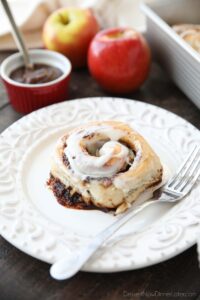 Apple Butter Cinnamon Roll on plate with a fork.