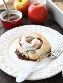 Apple Butter Cinnamon Roll on plate with a fork.