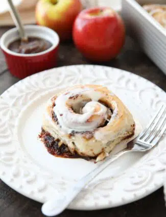Apple Butter Cinnamon Roll on plate with a fork.