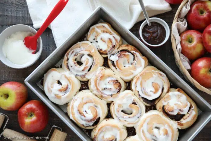 Pan full of apple butter cinnamon rolls with cream cheese glaze.