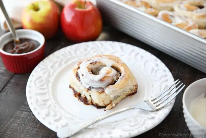 Side view of an apple butter cinnamon roll on a plate.