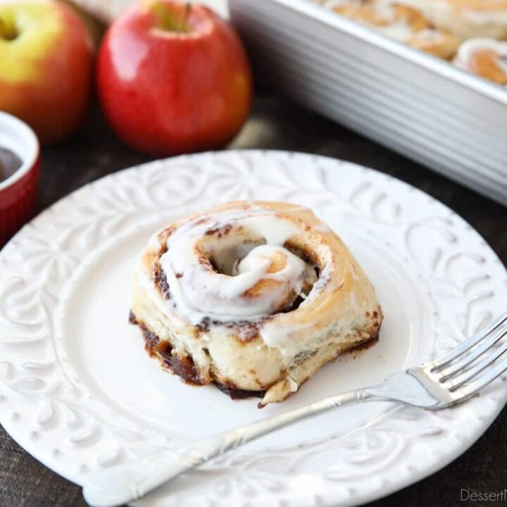 Side view of an apple butter cinnamon roll on a plate.