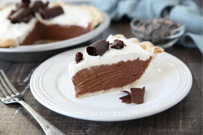 Piece of chocolate cream pie on a plate with chocolate shavings.