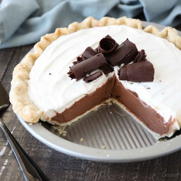 Top view of pie tin with a couple pieces taken out of the chocolate cream pie.