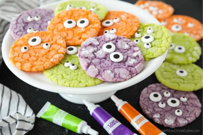 Side view of plate with colorful cookies topped with candy eyeballs.