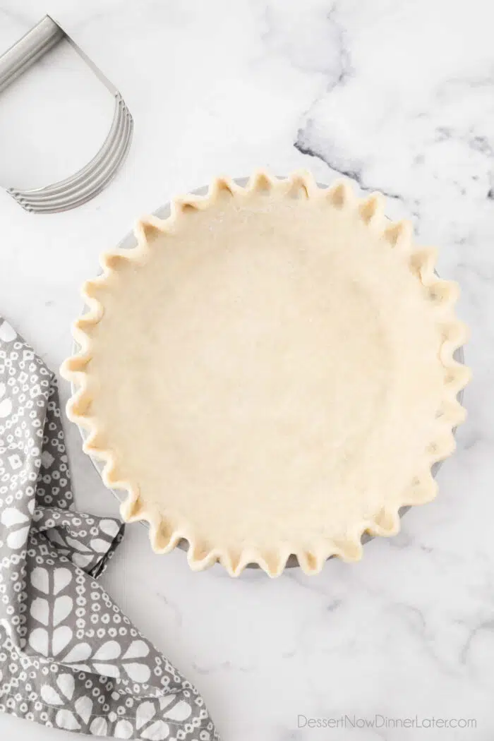 All butter pie crust fitted in pan with crimped edges.