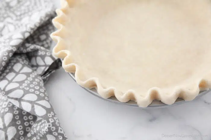 Close up of crimped edges of pie crust.