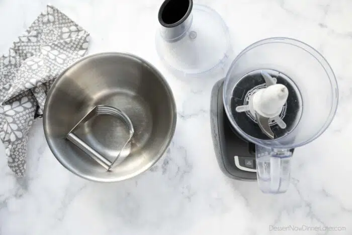 Two Pie Crust Tools. A bowl with a pastry blender and a food processor.