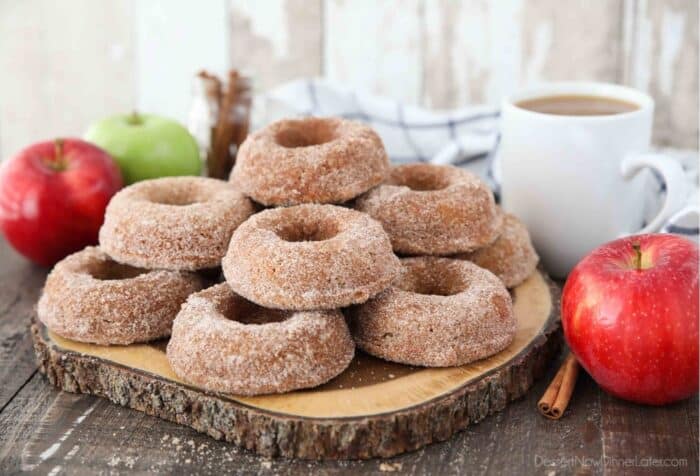 Side view of apple cider donuts on a cutting board.