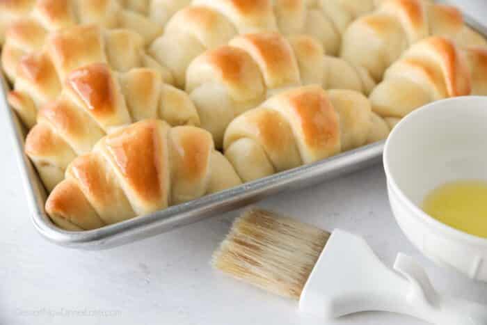 Close up of shiny butter topped crescent dinner rolls.