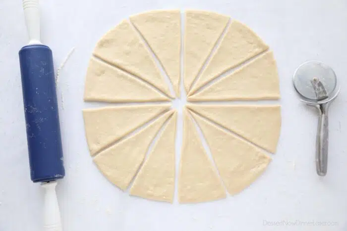 Dough rolled into a circle and cut into 12 triangle pieces.