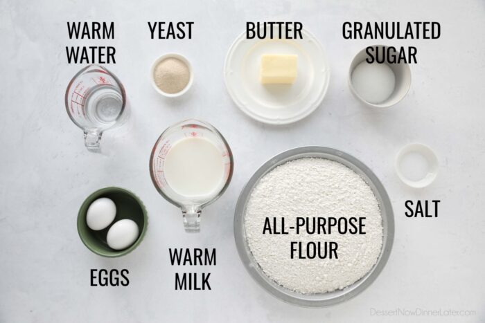 Ingredients for homemade crescent rolls: warm water, yeast, butter, granulated sugar, eggs, warm milk, all-purpose flour, and salt.