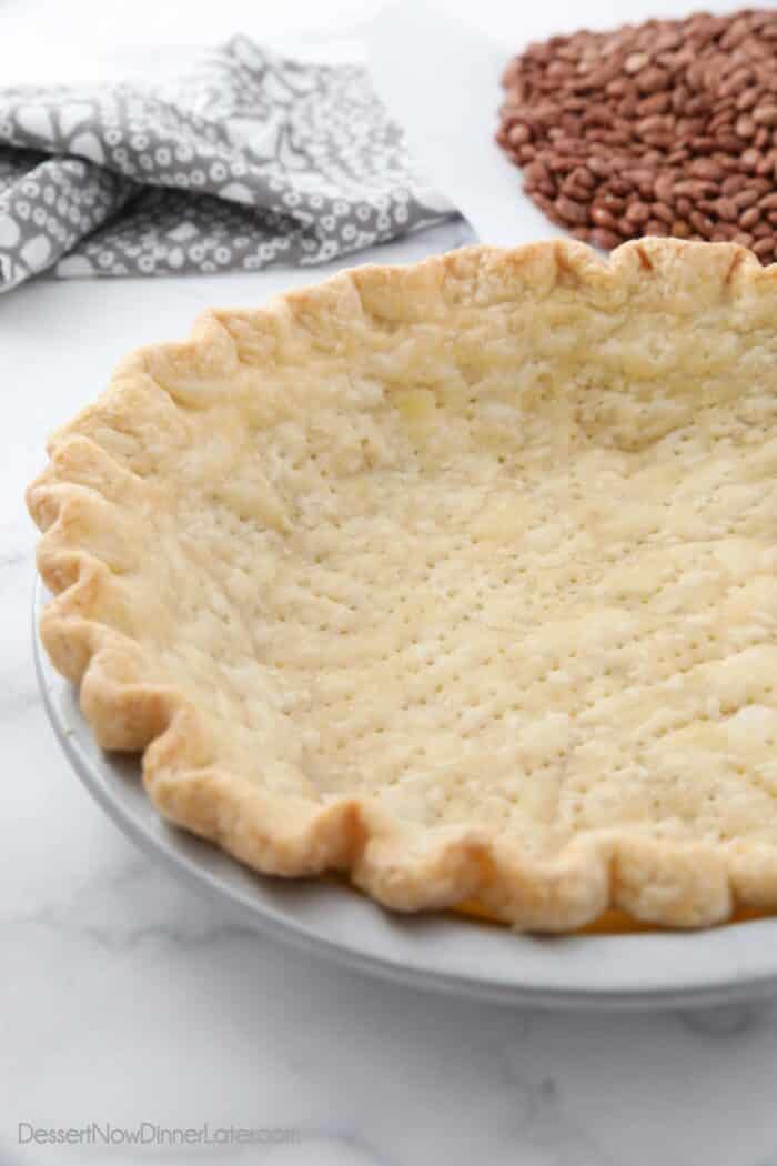 Side view of baked pie crust in pan.