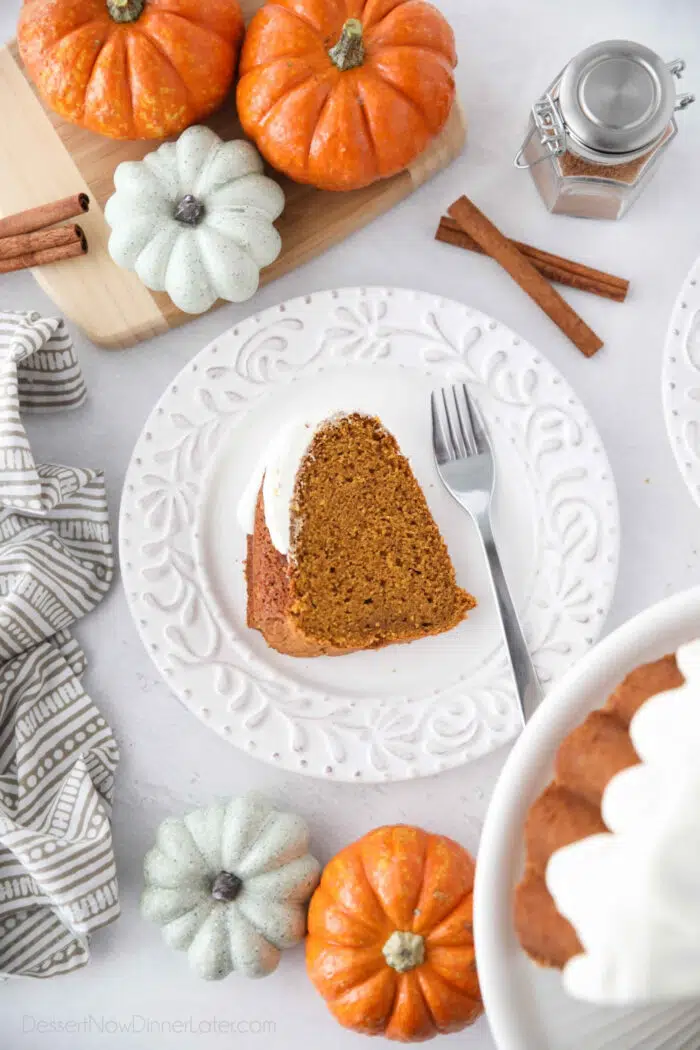 Slice of pumpkin bundt cake on a plate with a fork.