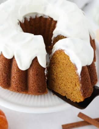 Top view of a slice of pumpkin bundt cake being removed with a cake server.