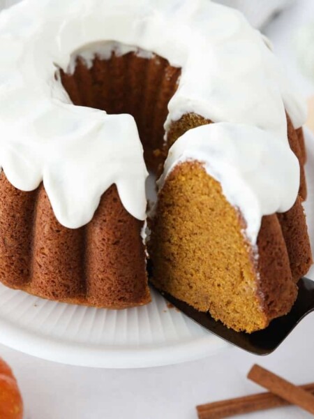 Top view of a slice of pumpkin bundt cake being removed with a cake server.